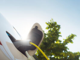 Charging an electric car with power supply cable.