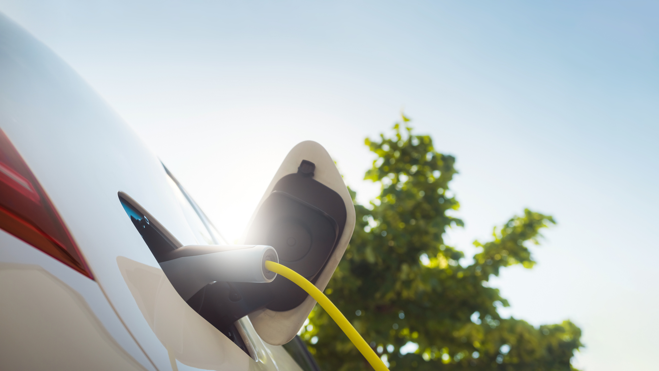 Charging an electric car with power supply cable.