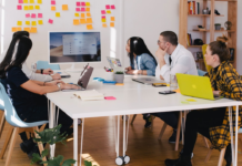 A team in an office discussing the sales cycle during a meeting