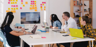 A team in an office discussing the sales cycle during a meeting